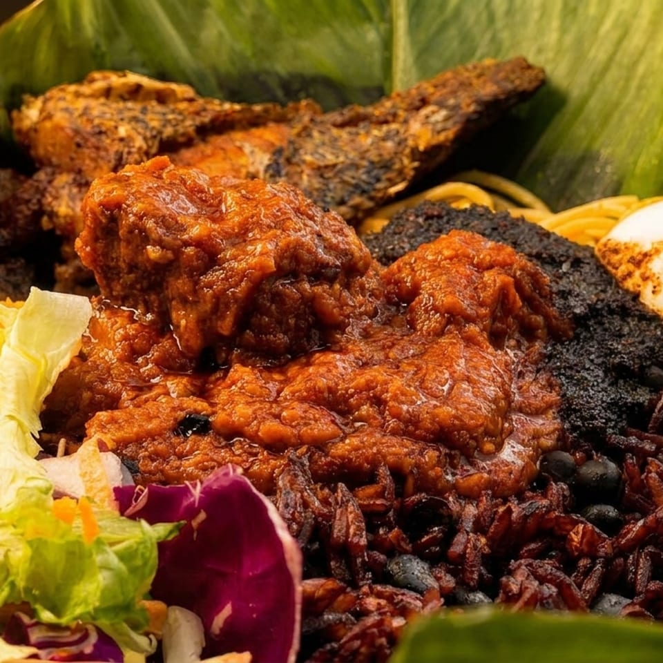 A vibrant bowl of West African food with plantains, fish, stew, rice, egg, and salad.